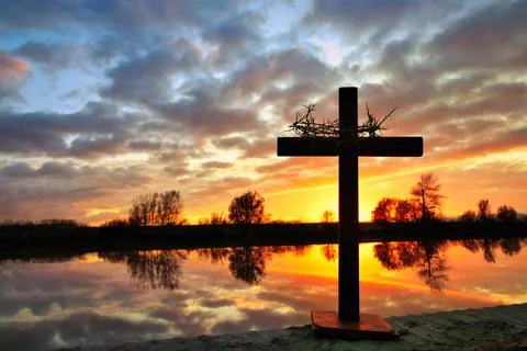 Cross With Crown of Thorns Reflection Waters Sunset Stock Photos