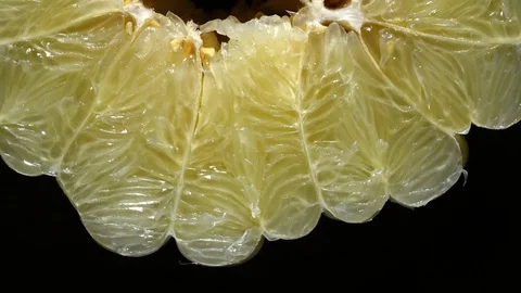 Cross cut close up of closely peeled huge pomelo, rotating with up center Stock Footage 78347482