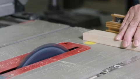 Cross cutting a board on a table saw Stock Footage 140066242