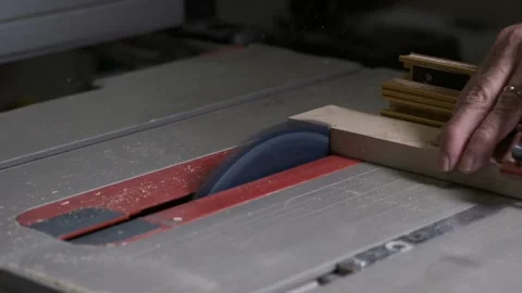 Cross cutting a board on a table saw slow motion Stock Footage 140066244