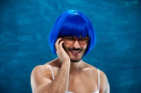 Cross dressing man posing in blue wig Stock Photos