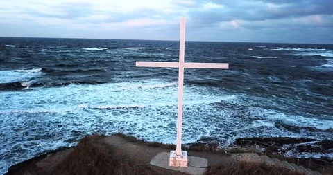 A cross at the edge of a cliff Stock Footage 94432999