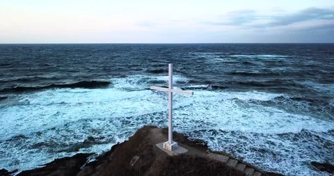 A cross at the edge of a cliff Stock Footage 94434476