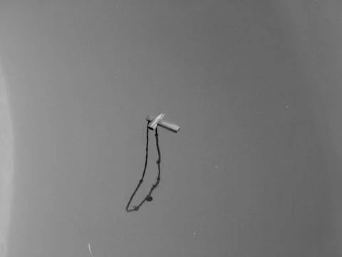 A cross floating in a pool Stock Photos