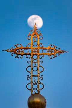 Cross in front of the moon Stock Photos