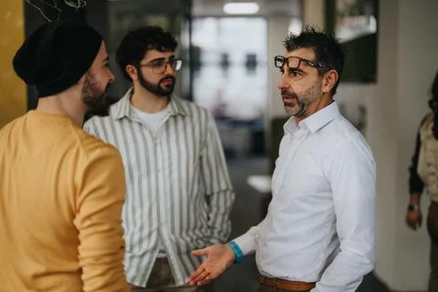 Cross generational people working in a creative office. Collaborating colleagues Stock Photos