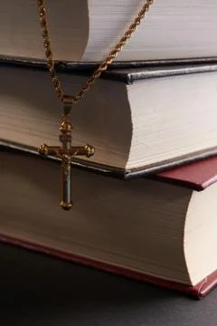 Cross hanging on background Book Stock Photos