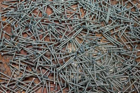 Cross head screws spread out on a workbench Stock Photos