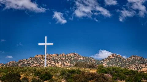 Cross on a hill in the mountains Stock Photos