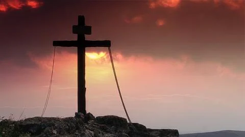 Cross with inscription on a dramatic sunset Stock Photos