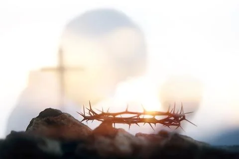 The cross of Jesus Christ, the crown of thorns, and a praying Christian Fotos Stock