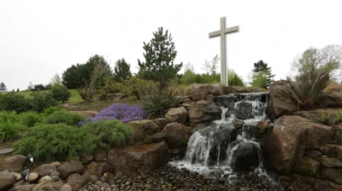Cross at Landscaped Waterfall Stock Footage 34403320