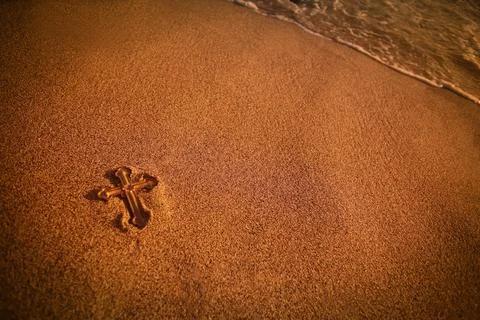 Cross Lying In The Sand Stock Photos