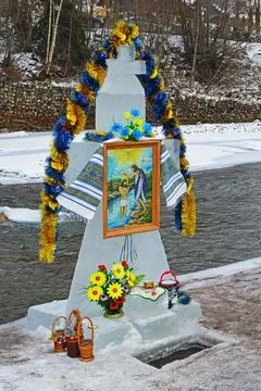 Cross made of ice by the river during the Epiphany Stock Photos