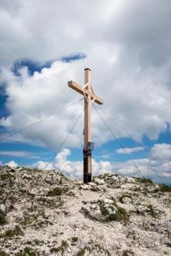 Cross on a mountain top with clouds Stock Photos