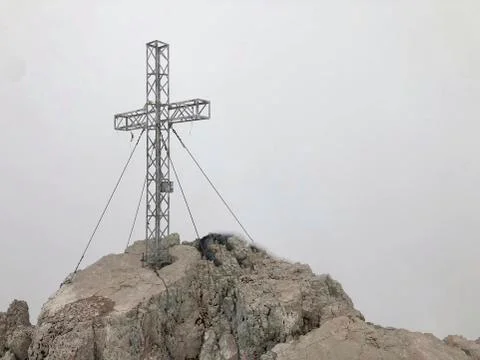 A cross on the mountains top Stock Photos