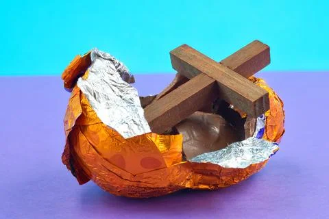 Cross In a Open Broken Easter on Purple Background Stock Photos