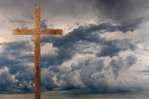 Cross over dark clouds Stock Photos