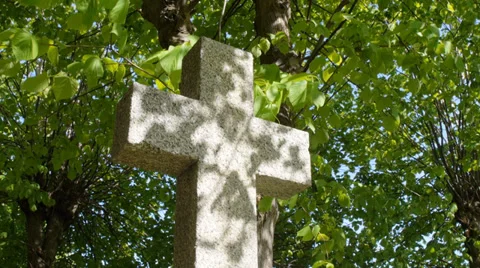 Cross over grave in dappled sunlight Stock Footage 38313182
