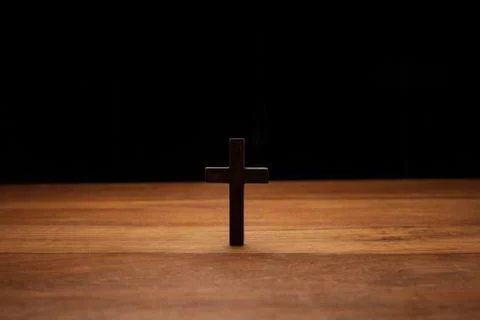 Cross over a wood table Stock Photos