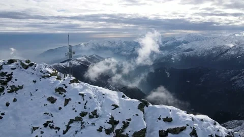 Cross on the peak of the mountain, some snow and clouds moving fast. Alps 4K Stock Footage 148031166