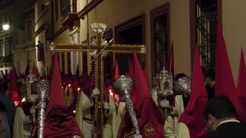 Cross With Red and White Capirotes During Semana Santa in Seville Stock Footage 335942525