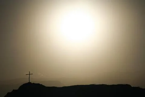 Cross on the rock Stock Photos