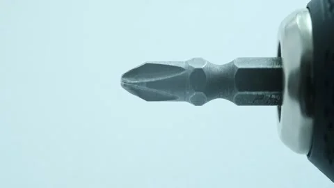 Cross screwdriver bit rotates in horizontal position on head of drill. Close-up. Stock Footage 247177358