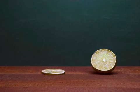 Cross Section Of A Lime And A Lime Slice On A Wooden Table. Green Background. Stock Photos