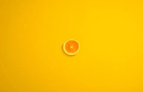 Cross section of orange with yellow background. Minimal concept art. Stock Photos