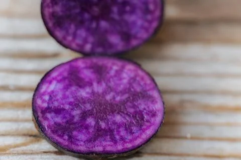 A cross-section of a potato on a marbled surface. Foto stock