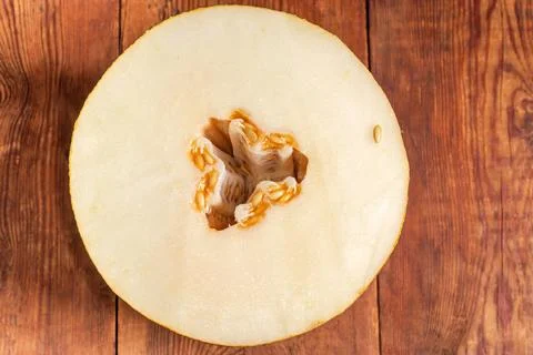 Cross-section of yellow ripe melon on table, top view Stock Photos