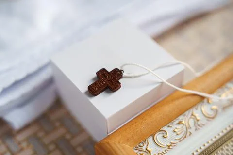 Cross on a small box with decorative frame in a simple setting Stock Photos