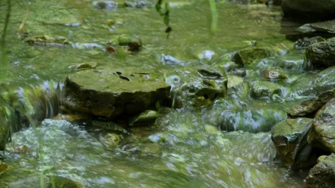 Cross the small mountain river on a mountain bike. The bike rides on the water Stock Footage 136362357