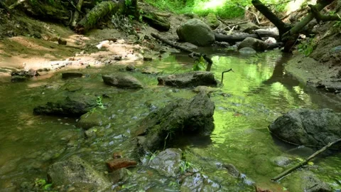 Cross the small mountain river on a mountain bike. The bike rides on the water Stock Footage 136362824
