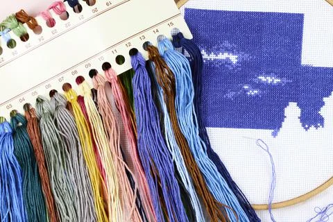 Cross stitch process. Threads, needle, hoop. Needlework and hobbies Stock Photos