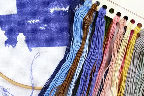 Cross stitch process. Threads, needle, hoop. Needlework and hobbies Stock Photos