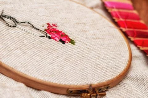 Cross stitching embroidery process. Needle embroidery frame threads. Hobby DI Stock Photos