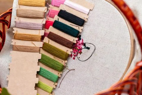 Cross stitching embroidery process. Needle embroidery frame threads. Hobby DI Stock Photos