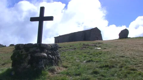 CROSS IN A STONE AND A MONASTERY BEHIND WITH FAST CLOUDS TIMELAPSE Stock Footage 96284874