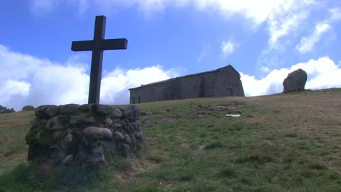 CROSS IN A STONE AND A MONASTERY BEHIND WITH FAST CLOUDS Stock Footage 96285151