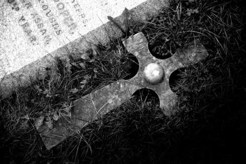 Cross at the tombstone Stock Photos