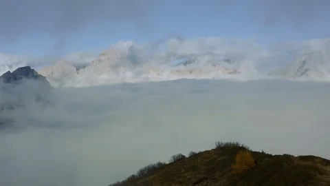 A cross on top of the Col de la Puina surrounded by a sea of clouds Stock Footage 129807686