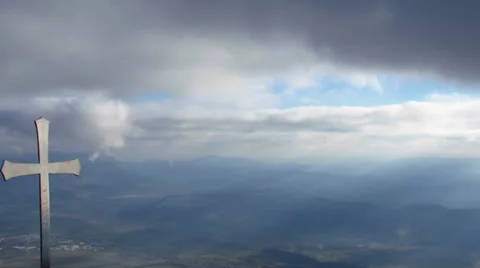 Cross on the top of a mountain - pan right Stock Footage 34536486
