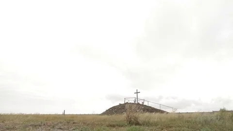 Cross on top of a mountain through the grass Stock Footage 78138537