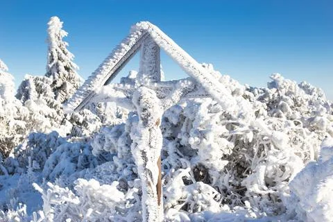 Cross on the top of the mountain in winter Stock Photos
