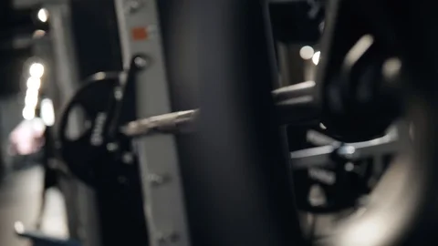 Cross training. Part of young man in sportswear lifting barbell at gym. Young Stock Footage 90430516