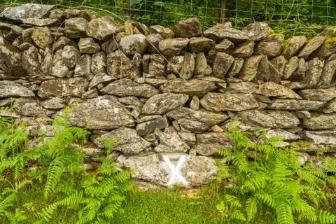 Cross on wall marking where wheel was found after explosion Stock Photos