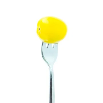 Cross yellow tomato with fork Stock Photos
