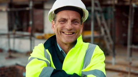 Crossed arms, man and face of construction manager on site with confidence for Stock Footage 336216170